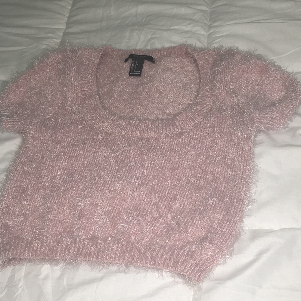 A pink feathered crop top
